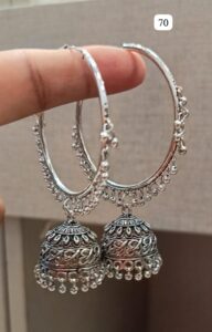 Pair of silver hoop earrings featuring decorative bells and intricate designs hanging from the hoops.