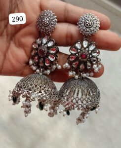 A pair of silver earrings featuring a floral design with gemstones and hanging embellishments.