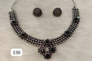 Black and silver jewelry set featuring a necklace and matching earrings with floral designs.