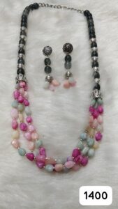 Multi-layered necklace featuring pink, blue, and gray beads with matching earrings.