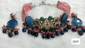 Traditional jewelry set featuring a necklace with blue and green stones and matching earrings with colorful beads.