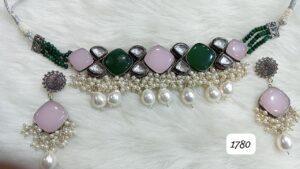 Necklace featuring green and pink stones with pearl embellishments and matching earrings.