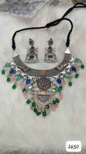 Traditional silver necklace adorned with colorful stones and matching earrings.