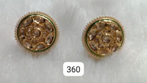 Pair of gold and green decorative earrings with intricate designs and gemstones.