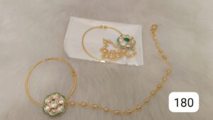 Gold hoop earrings featuring a floral design with green and white embellishments.