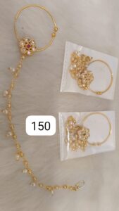 Gold jewelry set featuring a pendant with a floral design and matching earrings in clear packaging.