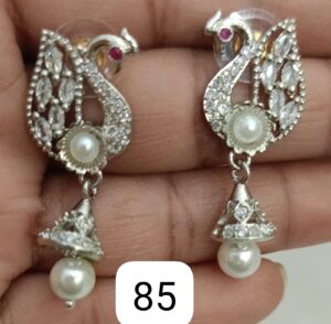 Pair of silver earrings shaped like swans, featuring pearls and decorative stones.