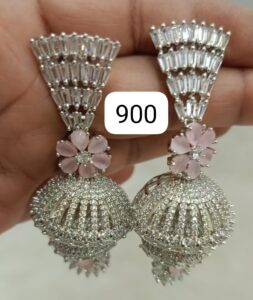 Pair of silver earrings featuring a floral design with pink gemstones and intricate detailing.