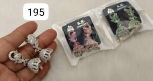 Two pairs of earrings displayed, one in silver and one in pink and green, packaged in A.K. Jewellery branding.