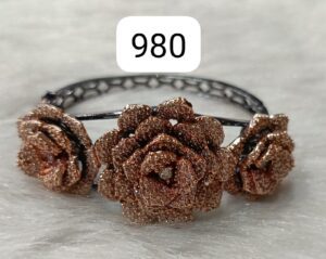 Bracelet featuring three rose-shaped designs made of rose gold with intricate detailing.