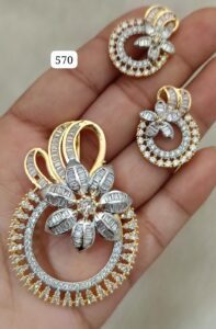 Gold and silver jewelry set featuring a floral design with diamonds on a hand.