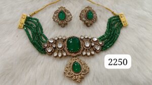 Jewelry set featuring a green stone necklace and matching earrings with intricate designs.