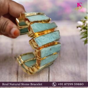 Gold and turquoise bracelet made with natural stones, showcasing a unique design with rectangular shapes.